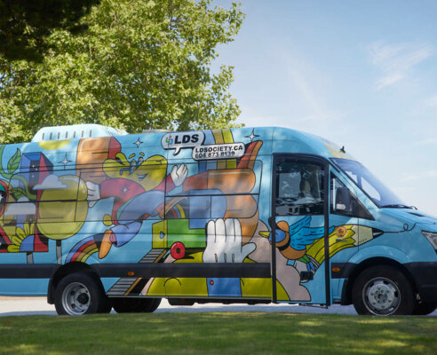 LDS mobile classroom learning bus covered in graphics