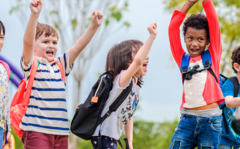 Kids raising their hands in a fun game