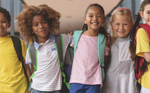 Row of kids at school with arms around each other