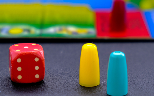 a die, game pieces and game board