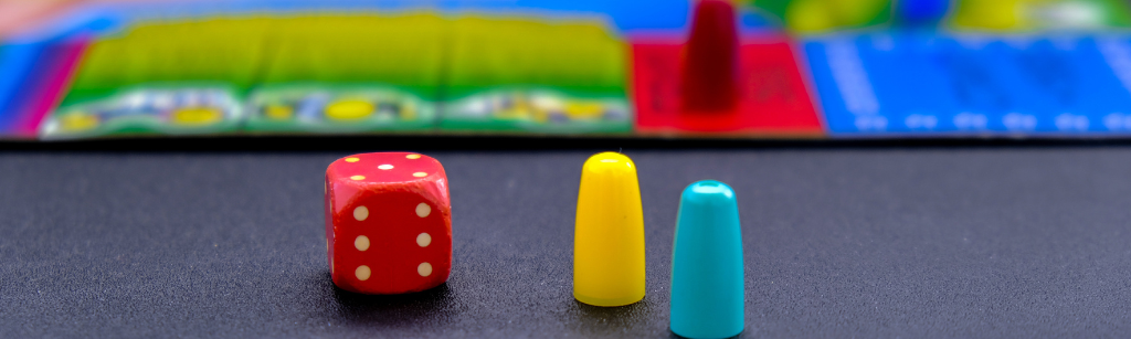 a die, game pieces and game board