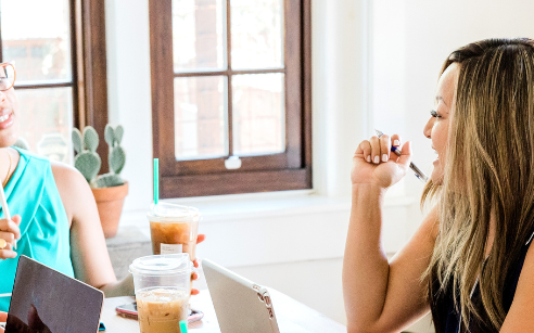 Women talking to two others in a meeting