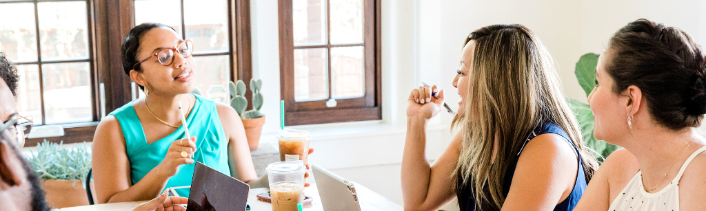 Women talking to two others in a meeting