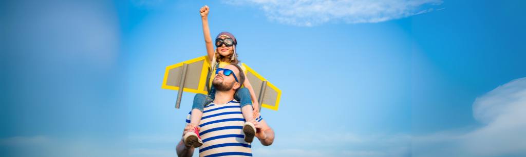 father and child with pay wings and fist pump