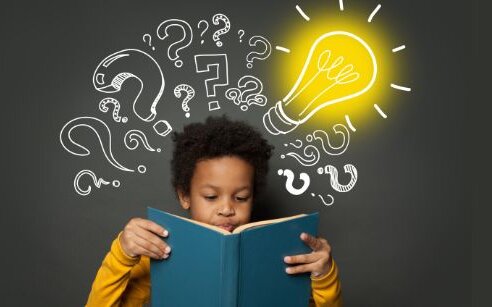 child reading with questions and symbols around his head