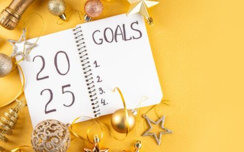 notebook for goals on yellow background