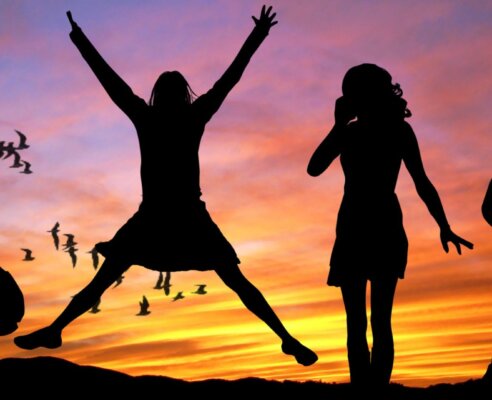 sunset background and four women in different poses shadowed