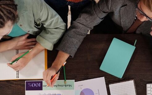 Work space with two people working on documents