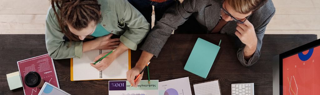 Work space with two people working on documents