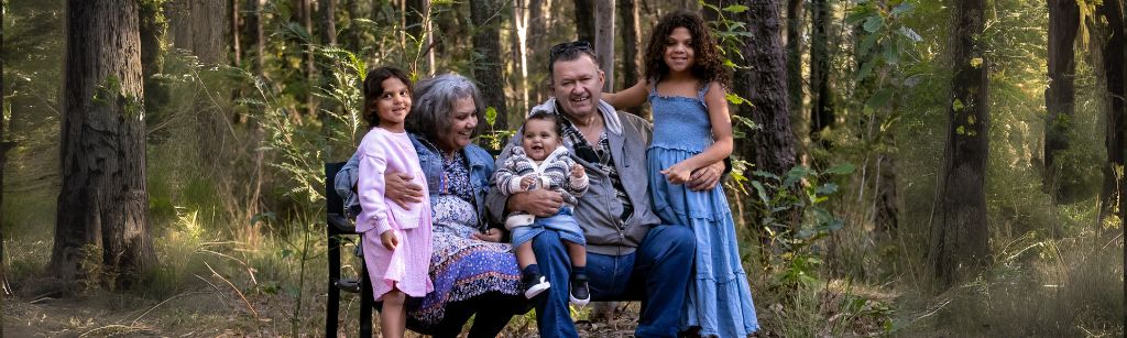 Family posing for photo in forest