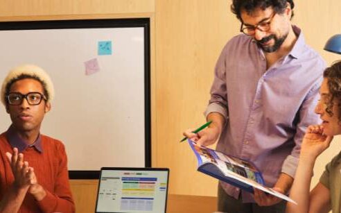 team of four working and sharing information