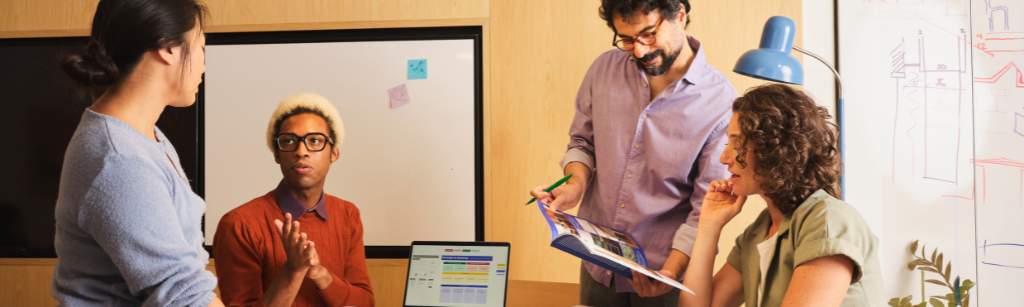 team of four working and sharing information