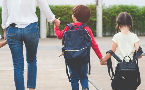 children with backpacks walking to school