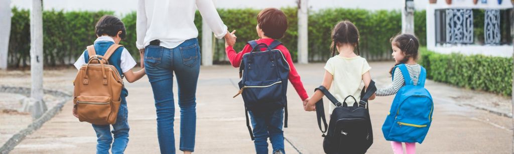children with backpacks walking to school